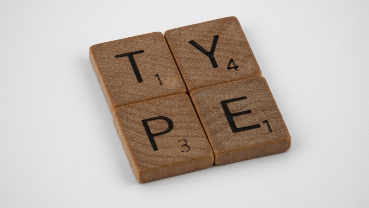 scrabble, scrabble pieces, lettering, letters, wood, scrabble tiles, white background, words, type, typography, design, layout,